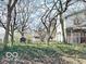 Fenced backyard with mature trees and a building in the back at 2505 E 17Th St, Indianapolis, IN 46218