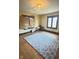 Bedroom with hardwood floors and large blue rug under large windows at 2505 E 17Th St, Indianapolis, IN 46218