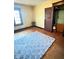 Bedroom with hardwood floors and large blue rug at 2505 E 17Th St, Indianapolis, IN 46218