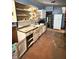 Narrow, dated kitchen featuring blue walls, peeling cabinets, and older appliances at 2505 E 17Th St, Indianapolis, IN 46218