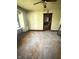 Hardwood floors in a living room with peeling paint and old decor at 2505 E 17Th St, Indianapolis, IN 46218