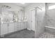 Modern bathroom featuring double sinks, white cabinets, large mirrors, and a walk-in shower with marble accents at 2786 Kipling Dr, Carmel, IN 46033
