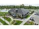 An aerial view shows the community center features landscaped walkways, convenient parking, and a nearby pond at 2786 Kipling Dr, Carmel, IN 46033