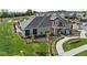 Aerial view of community center with manicured landscaping, adjacent to a pond and parking area at 2786 Kipling Dr, Carmel, IN 46033