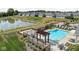 An aerial view shows the community pool with lounge chairs and tables, nestled by a tranquil pond at 2786 Kipling Dr, Carmel, IN 46033