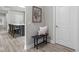 Cozy entryway includes a bench with pillows, a decorative painting, and a view into the kitchen at 2786 Kipling Dr, Carmel, IN 46033