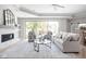 Bright living room with fireplace, sliding glass doors, modern furniture, and plenty of natural light at 2786 Kipling Dr, Carmel, IN 46033