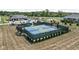 An aerial view showcases community pickleball courts next to a clubhouse, pool, and a scenic pond at 2786 Kipling Dr, Carmel, IN 46033