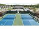 Aerial image of community pickleball courts with nets, with a clubhouse, pool, and pond nearby at 2786 Kipling Dr, Carmel, IN 46033