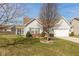 View of home with a well-maintained lawn, landscaping and attached garage at 3045 Sholty Ct, Cicero, IN 46034