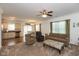 Open-concept living room with hardwood floors, neutral paint, ceiling fan, and kitchen in background at 3045 Sholty Ct, Cicero, IN 46034