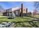 View of a brick townhouse with a grassy backyard and wooden privacy fence at 310 E St Clair St, Indianapolis, IN 46202