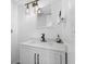 This bathroom features modern fixtures, white cabinets and industrial-style lighting at 310 E St Clair St, Indianapolis, IN 46202