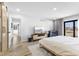 Bright bedroom featuring a bed, TV, crib, light-colored rug, wood floors and natural light at 310 E St Clair St, Indianapolis, IN 46202