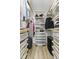 Organized walk-in closet with wooden shelves, metal baskets and hanging rods providing ample storage at 310 E St Clair St, Indianapolis, IN 46202
