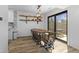 Dining area featuring a wooden table, modern chairs, shelving, and sliding glass door to the backyard at 310 E St Clair St, Indianapolis, IN 46202