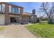 Brick townhouse with a well-manicured lawn and an attached garage, exuding curb appeal at 310 E St Clair St, Indianapolis, IN 46202