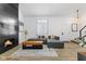 Open living room with fireplace, recessed lighting, gray couch, light colored flooring, and bright natural light at 310 E St Clair St, Indianapolis, IN 46202
