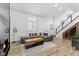 Open living room with fireplace, recessed lighting, gray couch, light colored flooring, and staircase with wine storage at 310 E St Clair St, Indianapolis, IN 46202