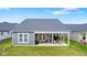 Spacious backyard featuring a covered patio area with outdoor seating and lush green grass, perfect for entertaining at 3121 Arkle Rd, Westfield, IN 46074