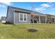 Well-maintained backyard featuring a covered patio area and lush green grass, creating a serene outdoor space at 3121 Arkle Rd, Westfield, IN 46074