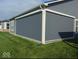 Enclosed patio with a gray privacy screen providing shade and seclusion from the yard with green grass at 3121 Arkle Rd, Westfield, IN 46074