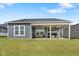 Spacious backyard with a covered patio, comfortable seating, and a grill, perfect for outdoor gatherings at 3121 Arkle Rd, Westfield, IN 46074
