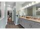 Bathroom with dual sink vanity, granite countertops, modern fixtures, and walk in closet at 3121 Arkle Rd, Westfield, IN 46074