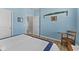 Bedroom featuring a window view, blue walls, wood flooring, and side chair at 3121 Arkle Rd, Westfield, IN 46074