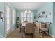 A sunlit dining room with a wooden table, modern chandelier, and stylish decor at 3121 Arkle Rd, Westfield, IN 46074