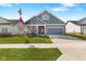 Inviting single-Gathering home with a well-maintained lawn, American flag, and a cozy front porch area at 3121 Arkle Rd, Westfield, IN 46074