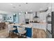 A modern kitchen with white cabinets, stainless steel appliances, and a blue kitchen island at 3121 Arkle Rd, Westfield, IN 46074