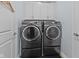 Efficient laundry room with modern appliances and storage cabinets above washer and dryer at 3121 Arkle Rd, Westfield, IN 46074