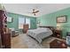 Spacious main bedroom with light wood floors, area rug, ceiling fan, and serene backyard views at 3121 Arkle Rd, Westfield, IN 46074