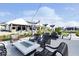 Outdoor patio includes fire pit, lounge chairs, string lights, and clubhouse in the background at 3121 Arkle Rd, Westfield, IN 46074