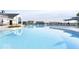 Outdoor swimming pool is surrounded by lounge chairs, umbrellas, and neighborhood homes at 3121 Arkle Rd, Westfield, IN 46074