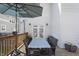 Back deck with table, seating, umbrella, and access to the home through french doors at 3345 Ruckle St, Indianapolis, IN 46205