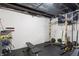 Spacious basement with fitness equipment including a weight rack and adjustable bench at 3345 Ruckle St, Indianapolis, IN 46205