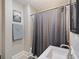 Cozy bathroom featuring a shower with neutral tile, modern vanity, calming decor, and space-saving design elements at 3345 Ruckle St, Indianapolis, IN 46205