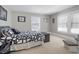 Charming bedroom featuring neutral carpet, light walls, natural light, and a cozy decorative touches, creating a serene space at 3345 Ruckle St, Indianapolis, IN 46205