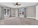 Spacious bedroom featuring neutral carpet, gray walls, natural light from windows, a ceiling fan and a comfortable layout at 3345 Ruckle St, Indianapolis, IN 46205