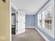 Bright bedroom featuring blue walls, plush neutral carpet, natural light from windows, and a calming, airy atmosphere at 3345 Ruckle St, Indianapolis, IN 46205