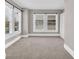 Bright bedroom featuring neutral carpet, light walls, ample natural light from windows, and built-in shelving at 3345 Ruckle St, Indianapolis, IN 46205