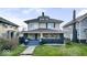 Charming two-story home with a covered front porch and well-maintained lawn at 3345 Ruckle St, Indianapolis, IN 46205