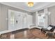 Welcoming foyer featuring hardwood floors, a decorative light fixture, and a coat rack with seating at 3345 Ruckle St, Indianapolis, IN 46205