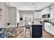 Modern kitchen featuring white cabinets, stainless steel appliances, and an island with bar seating at 3345 Ruckle St, Indianapolis, IN 46205