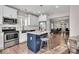 Well-lit kitchen features stainless steel appliances, white cabinets, and a center island with bar seating at 3345 Ruckle St, Indianapolis, IN 46205