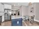 Bright kitchen with stainless steel appliances, a center island, and a dining table with chairs at 3345 Ruckle St, Indianapolis, IN 46205