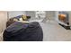 A cozy living room features a gray couch, beanbag chair, play gym, and a large TV at 3345 Ruckle St, Indianapolis, IN 46205