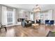 Bright living room with hardwood floors, large windows, and comfortable seating arrangements at 3345 Ruckle St, Indianapolis, IN 46205